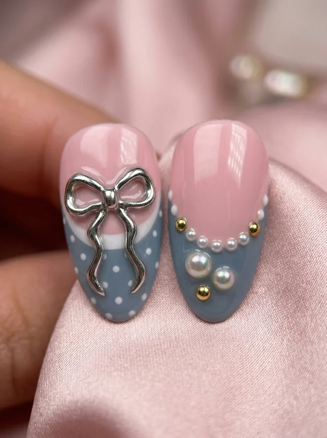Close-up of silver bow and pearl nail decorations